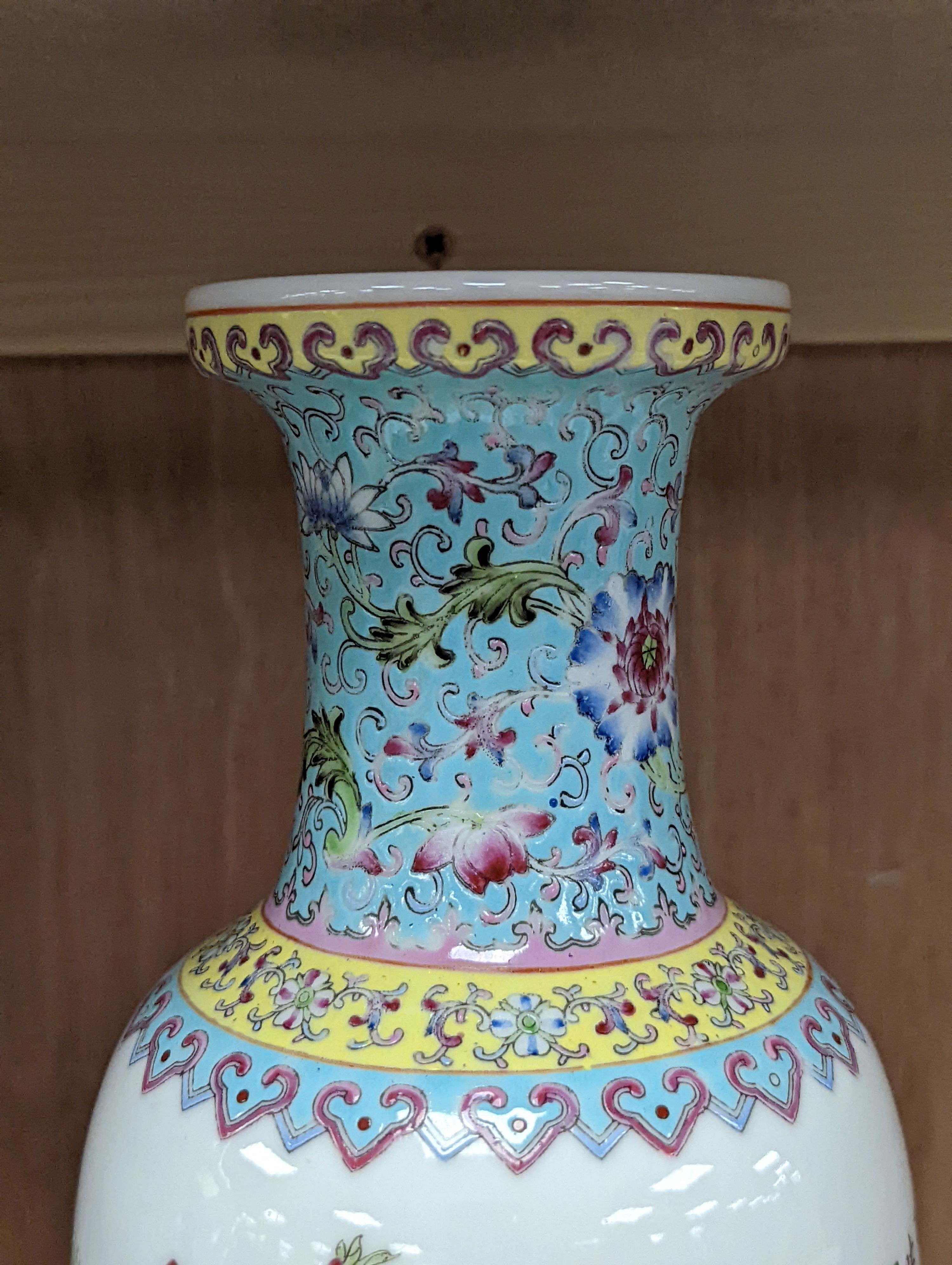 A pair of Chinese famille rose vases decorated with peacocks, 31cm
